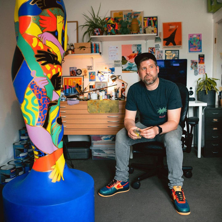 photo of Carl AKA Holy Moly in his studio surrounded by his work